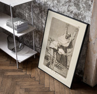 Grotesque figures screaming with raised arms poster in a black frame leaning beside a shelf in a raw-plaster loft