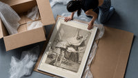 Grotesque figures screaming with raised arms framed print being unpacked from protective bubble wrap and a box