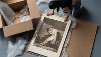 man embracing dying woman framed print being unpacked from protective bubble wrap and a box