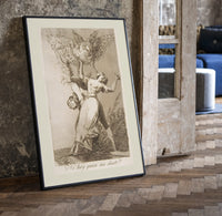Owl above bound couple print in a black frame leaning beside a vintage door on parquet