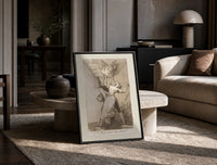 Owl above bound couple print in a black frame leaning on a travertine table in a sunlit lounge