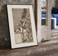 Sleeping man surrounded by owls and bats print in a black frame leaning beside a vintage door on parquet