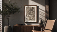 Sleeping man surrounded by owls and bats poster framed above a fluted sideboard beside an olive tree