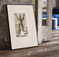 Kneeling woman praying before robed figure print in a black frame leaning beside a vintage door on parquet