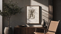 Kneeling woman praying before robed figure poster framed above a fluted sideboard beside an olive tree