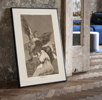 Winged demon carrying frightened figure print in a black frame leaning beside a vintage door on parquet