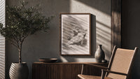 Man grieving over collapsed woman poster framed above a fluted sideboard beside an olive tree