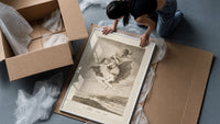Witches flying with monkey demon framed print being unpacked from protective bubble wrap and a box