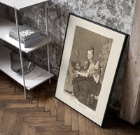 Grotesque figures spinning thread poster in a black frame leaning beside a shelf in a raw-plaster loft