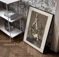 Grotesque figures climbing atop one another poster in a black frame leaning beside a shelf in a raw-plaster loft
