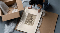 witch scene with goat demon framed print being unpacked from protective bubble wrap and a box