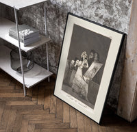 Old woman at vanity mirror poster in a black frame leaning beside a shelf in a raw-plaster loft