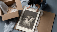 Old woman at vanity mirror framed print being unpacked from protective bubble wrap and a box