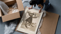 Flying woman above three men framed print being unpacked from protective bubble wrap and a box