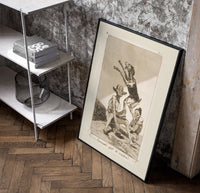 Grotesque demons and goat figure poster in a black frame leaning beside a shelf in a raw-plaster loft