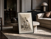 Grotesque demons and goat figure print in a black frame leaning on a travertine table in a sunlit lounge