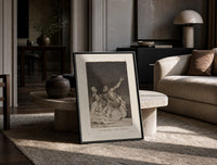 Grotesque nude figures under night sky print in a black frame leaning on a travertine table in a sunlit lounge