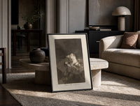 struggling figures with flying witches print in a black frame leaning on a travertine table in a sunlit lounge
