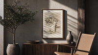 Woman fleeing winged demons poster framed above a fluted sideboard beside an olive tree