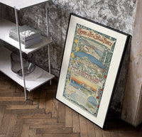 French Riviera coastal town views poster in a black frame leaning beside a shelf in a raw-plaster loft