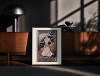 Black-framed Joan of Arc in armor print on a moody console with designer coffee-table books