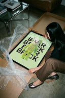 The Glow-in-dark skeleton Bearbrick figure poster shown across its range of print sizes
