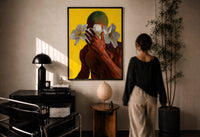 Green Hair with White Flowers print in a black frame on a sunlit plaster wall, a woman looking on beside a mushroom lamp