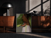 Black-framed Green Tie-Back Blouse and White Trousers print on the floor in front of a dark wooden console