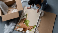 Green Woven Stiletto Sandals framed print being unpacked from protective bubble wrap and a box