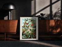 Black-framed Colorful hummingbirds among tropical foliage print on a moody console with designer coffee-table books