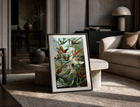 Colorful hummingbirds among tropical foliage print in a black frame leaning on a travertine table in a sunlit lounge