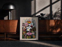Black-framed Botanical illustration of various orchids print on a moody console with designer coffee-table books