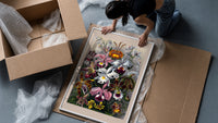 Botanical illustration of various orchids framed print being unpacked from protective bubble wrap and a box