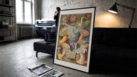 Sea anemones illustration print in a slim black frame leaning on a dark sofa in a concrete print studio