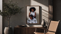 Hair Braiding Scene with Two Figures poster framed above a fluted sideboard beside a potted tree
