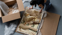 Hair Claw and Cosmetic Tube framed print being unpacked from protective bubble wrap and a box