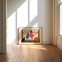 Two children bobbing for apples print in an oak frame on a sunlit wood floor beneath tall window light