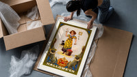 Girl holding snake with black cat framed print being unpacked from protective bubble wrap and a box