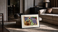 Clown bobbing for apples print in a slim black frame leaning on a travertine coffee table