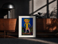 Black-framed Anthropomorphic pumpkin-headed corn figure print on a moody console with designer coffee-table books