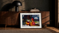 Witch girl sitting by cauldron fire print in a black frame leaning against a walnut console in lamplight