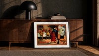 Witch and devils at Halloween feast print in a black frame leaning against a walnut console in lamplight