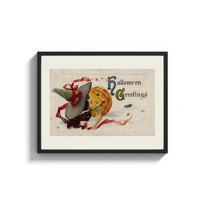 Framed Witch kissing a jack-o-lantern pumpkin print shown as a wide statement piece on a clean white wall