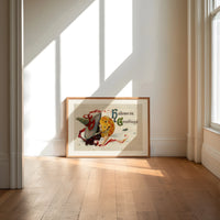 Witch kissing a jack-o-lantern pumpkin print in an oak frame on a sunlit wood floor beneath tall window light