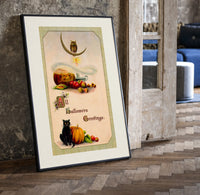 Vintage Halloween owl cat pumpkin print in a black frame leaning beside a vintage door on parquet