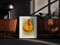 Black-framed Red devil sitting on jack-o-lantern print on a moody console with designer coffee-table books