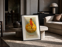 Red devil sitting on jack-o-lantern print in a black frame leaning on a travertine table in a sunlit lounge