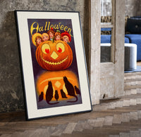 Vintage jack-o'-lantern with children's faces print in a black frame leaning beside a vintage door on parquet