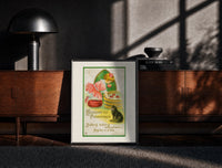 Black-framed Girl bobbing for apples with cat print on a moody console with designer coffee-table books