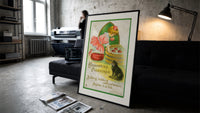 Girl bobbing for apples with cat print in a slim black frame leaning on a dark sofa in a concrete print studio